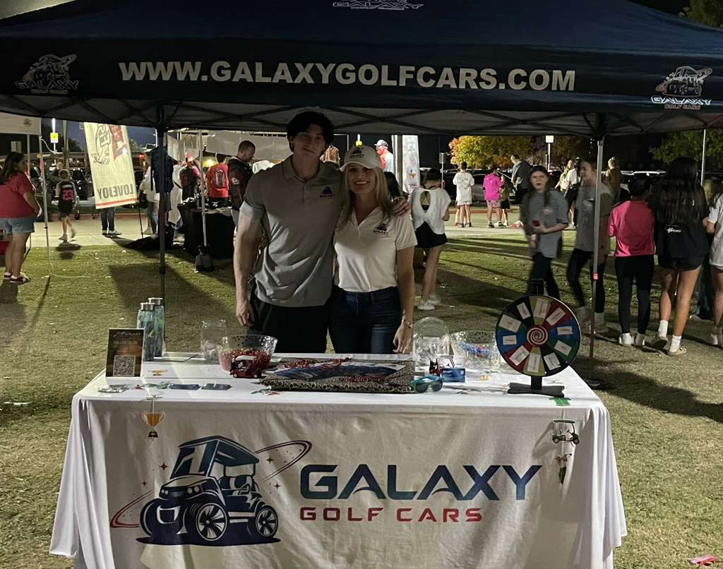 Galaxy Golf Cars team at their stand during Leopard Friday 2025 in Lovejoy Texas, showcasing custom and electric golf carts at a local community event.