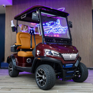 Conquest S20 electric golf cart in burgundy with tan premium seats and LED lighting at Galaxy Golf Cars showroom
