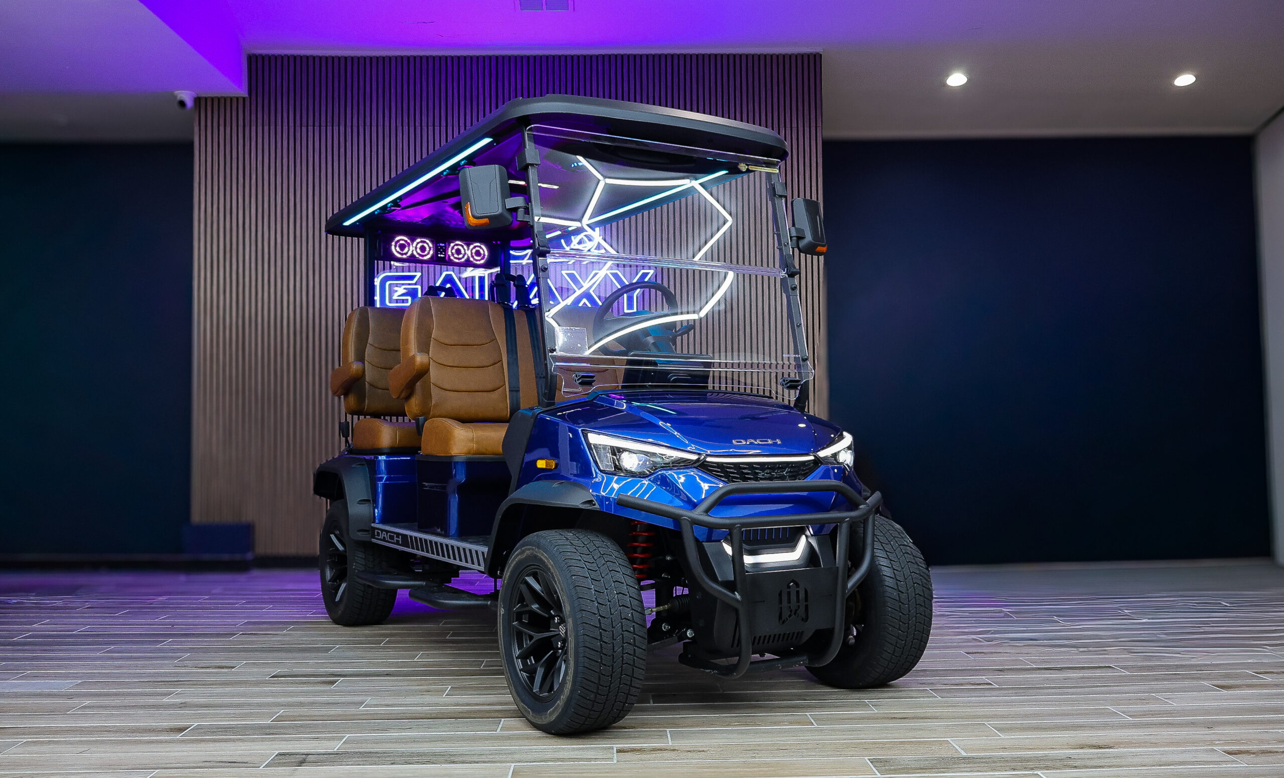 Blue Dach electric golf cart with premium brown seats and full windshield at Galaxy Golf Cars showroom