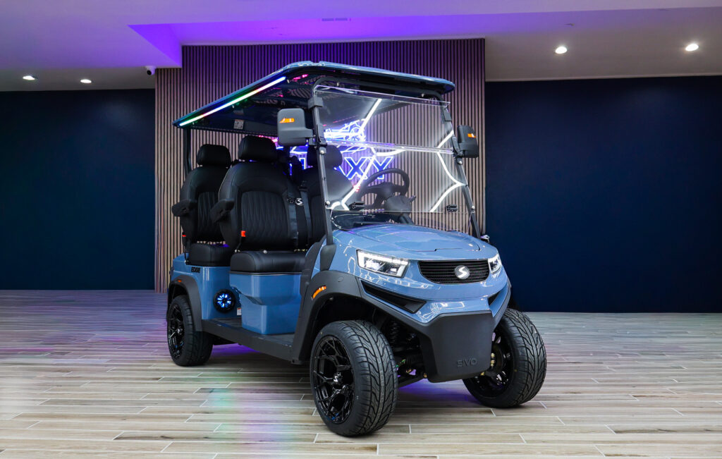 Blue Sivo Edge 4F golf cart with forward-facing seating displayed in the Galaxy Golf Cars showroom