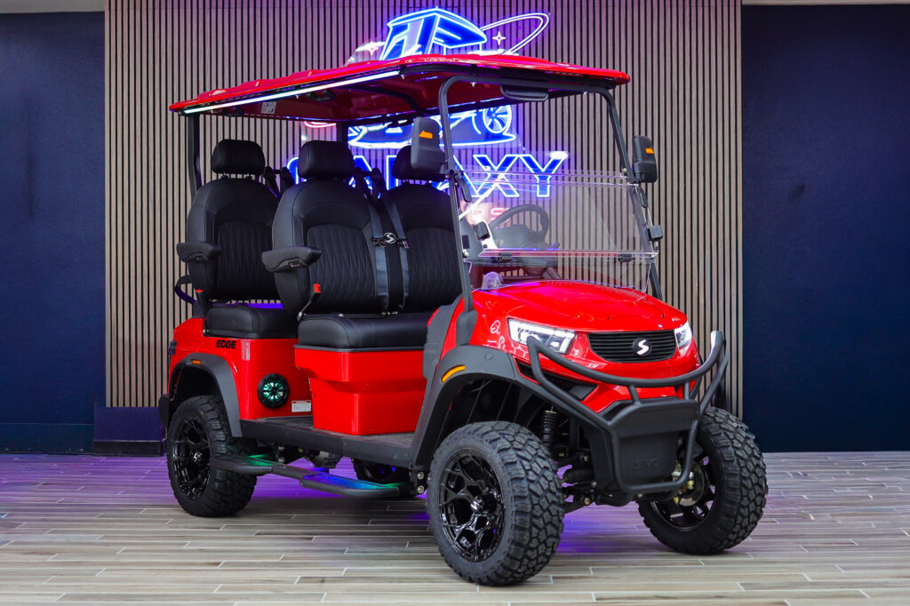 Red Sivo Edge 4F Lifted golf cart with forward-facing seating displayed in the Galaxy Golf Cars showroom