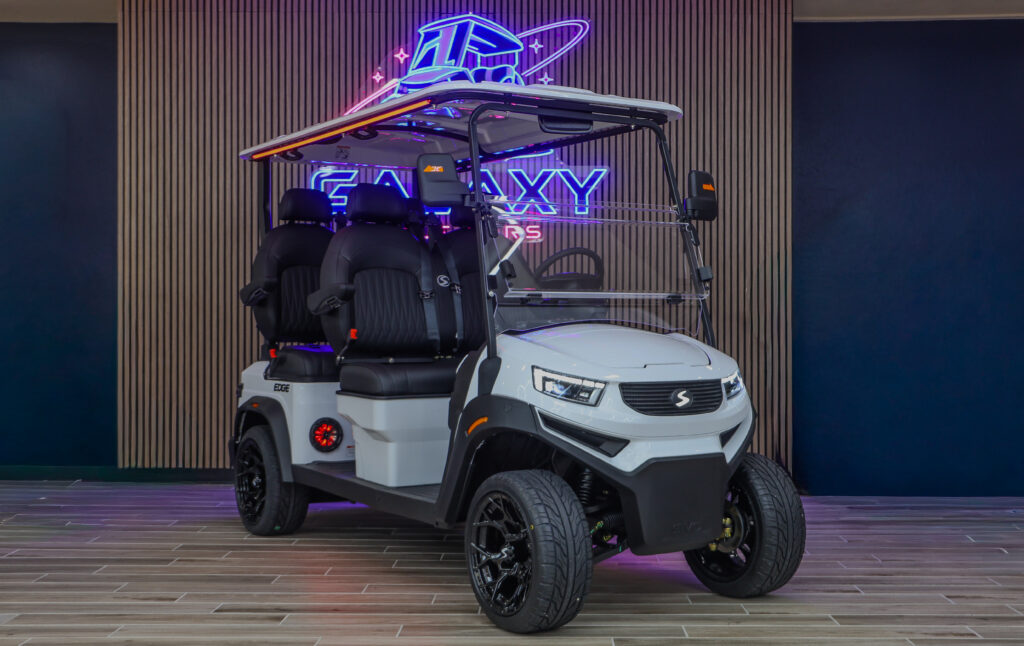White Sivo Edge 4F golf cart with forward-facing seating displayed in the Galaxy Golf Cars showroom