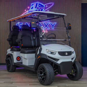 White Sivo Edge 4F golf cart with forward-facing seating displayed in the Galaxy Golf Cars showroom