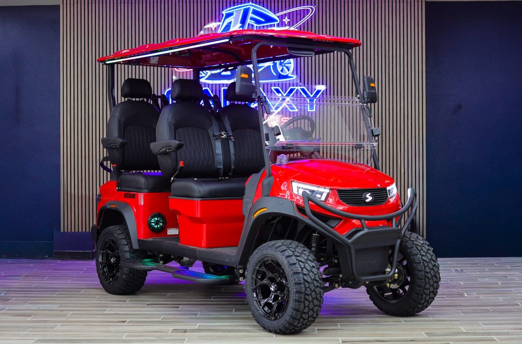 Red Sivo Edge 4F Lifted golf cart with forward-facing seating displayed in the Galaxy Golf Cars showroom